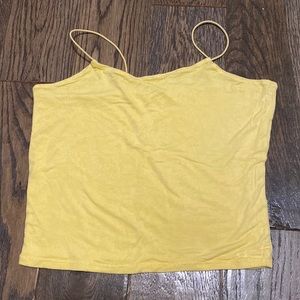 This is a pastel yellow cropped tank top, it is a kids large from urban kids.
